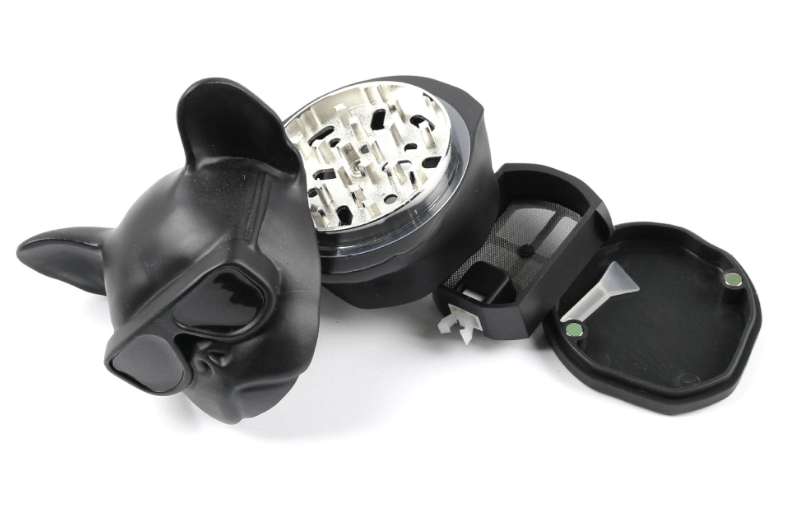 A partially open French Bulldog Grinder reveals its inner workings, viewed from above against a plain white background.