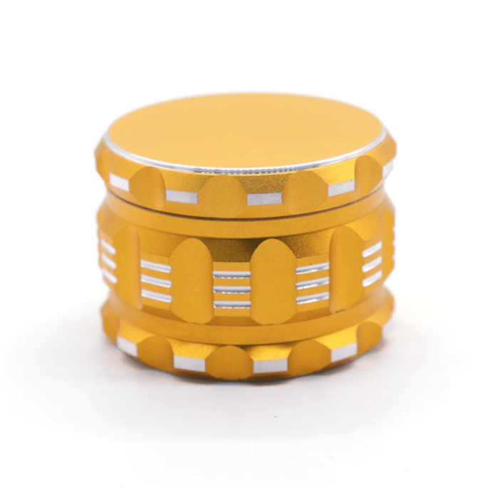 A close-up, angled view of the 4 Piece Aluminum Drum Shape Grinder, showcasing its metallic finish and segmented design.