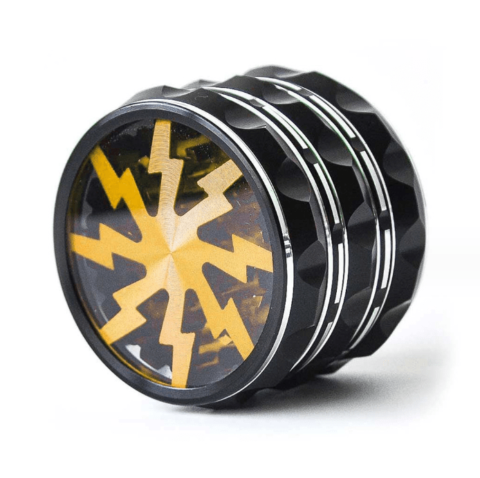 A close-up, angled view of the 4 Piece Aluminum Lighting Teeth Grinder, showcasing its metallic teeth against a dark interior.