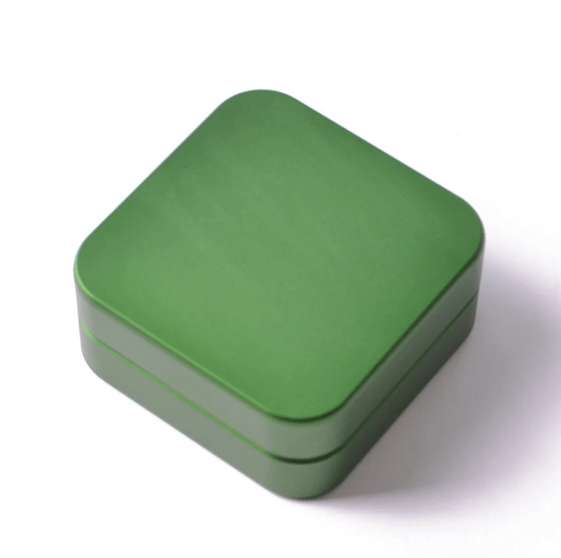 Overhead view of the 2 Piece Aluminum Square Grinder, showcasing its sleek, square design and metallic finish.