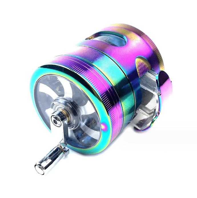 A detailed view of the 3.5" 4 Piece Hand Crank Grinder with Chamber Window, showcasing its metallic finish and transparent viewing chamber.