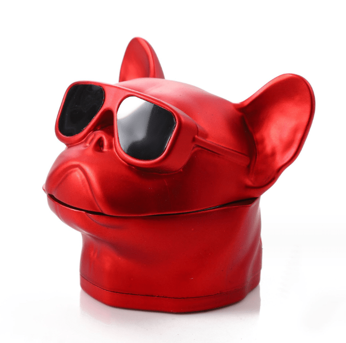 Front view of the French Bulldog Grinder, a red, sculptural grinder resembling a bulldog’s head against a plain white background.