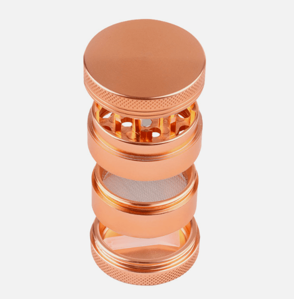 A close-up, angled view of the 4-Piece Zinc Grinder, showcasing its stacked, metallic tiers and textured surface.