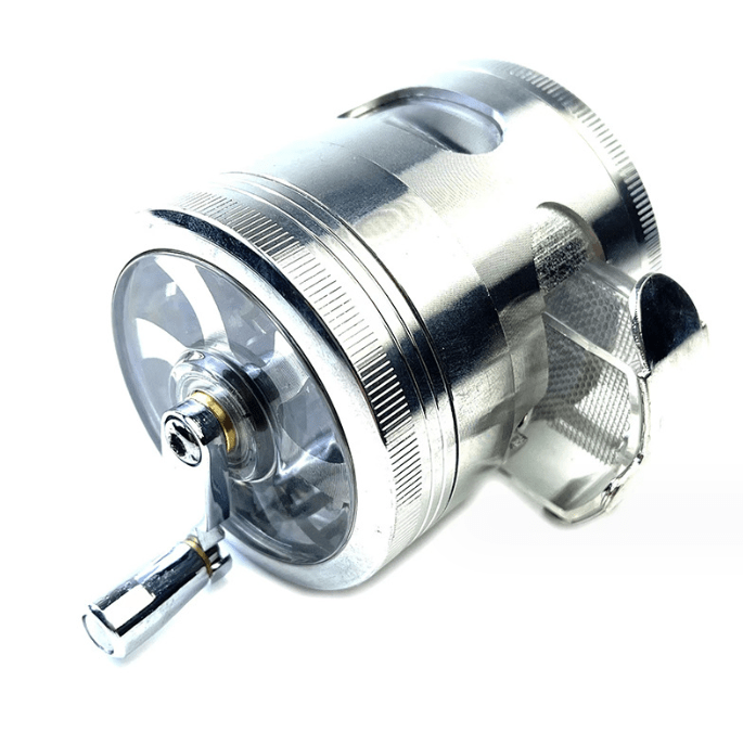 A side view of the 3.5" 4 Piece Hand Crank Grinder with Chamber Window, revealing its metallic finish and transparent viewing chamber.
