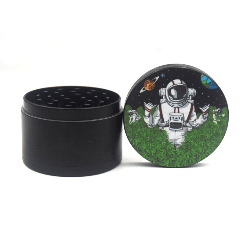 A top-down view of the 4 Piece 2.5" Trip to the Moon Grinder, decorated with a space-themed graphic on its metallic lid.