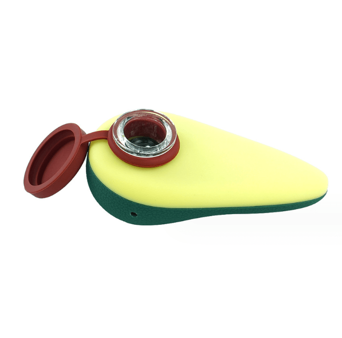 A slightly angled view of the 4'' Silicone Avocado Hand Pipe with Lid, showcasing its green body and removable red cap.