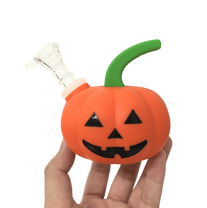 A close-up, angled view of the Silicone Halloween Pumpkin Jack-o'-lantern Hand Pipe, displaying its orange, jack-o'-lantern face design.