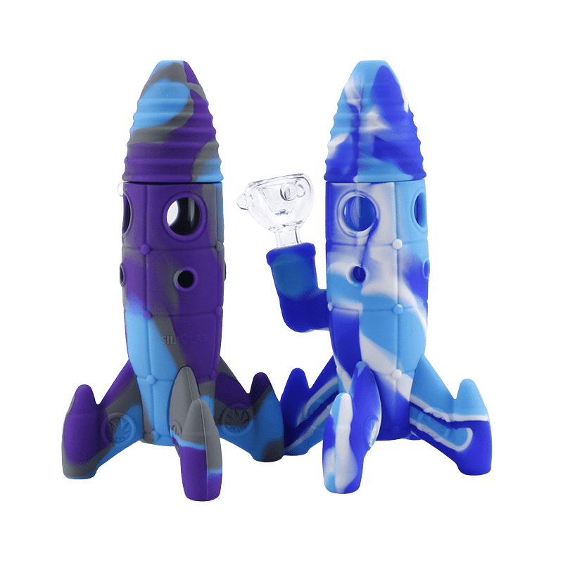 Front-facing pair of Silicone and Glass Rocket Ship Mini Bong rockets in marbled purple and blue, one with a clear glass bowl.