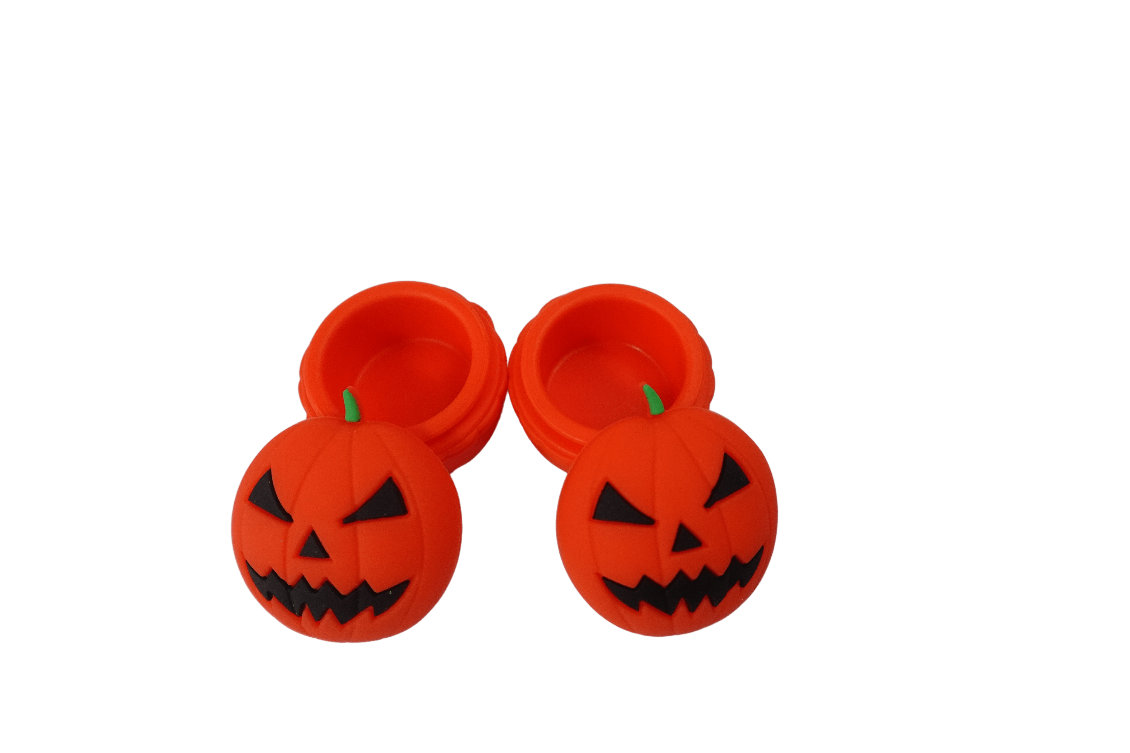 Top-down view of two open 15 ml Pumpkin Silicone Wax Oil Concentrate Vaporizer Cream Container jars showing bright orange jack-o'-lantern lids and hollow interiors.