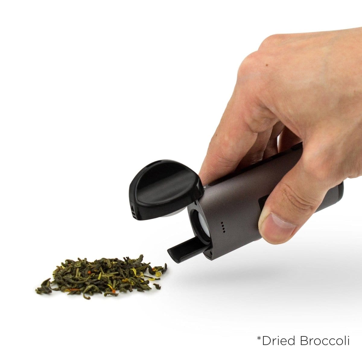 A hand holds the Cloudious9 Atomic9 Vaporizer, open to reveal its interior, against a bright white backdrop.