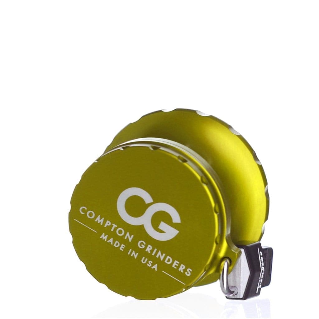 A slightly angled view of the Compton Vault, showcasing its sleek, silver design with a small loop attachment.