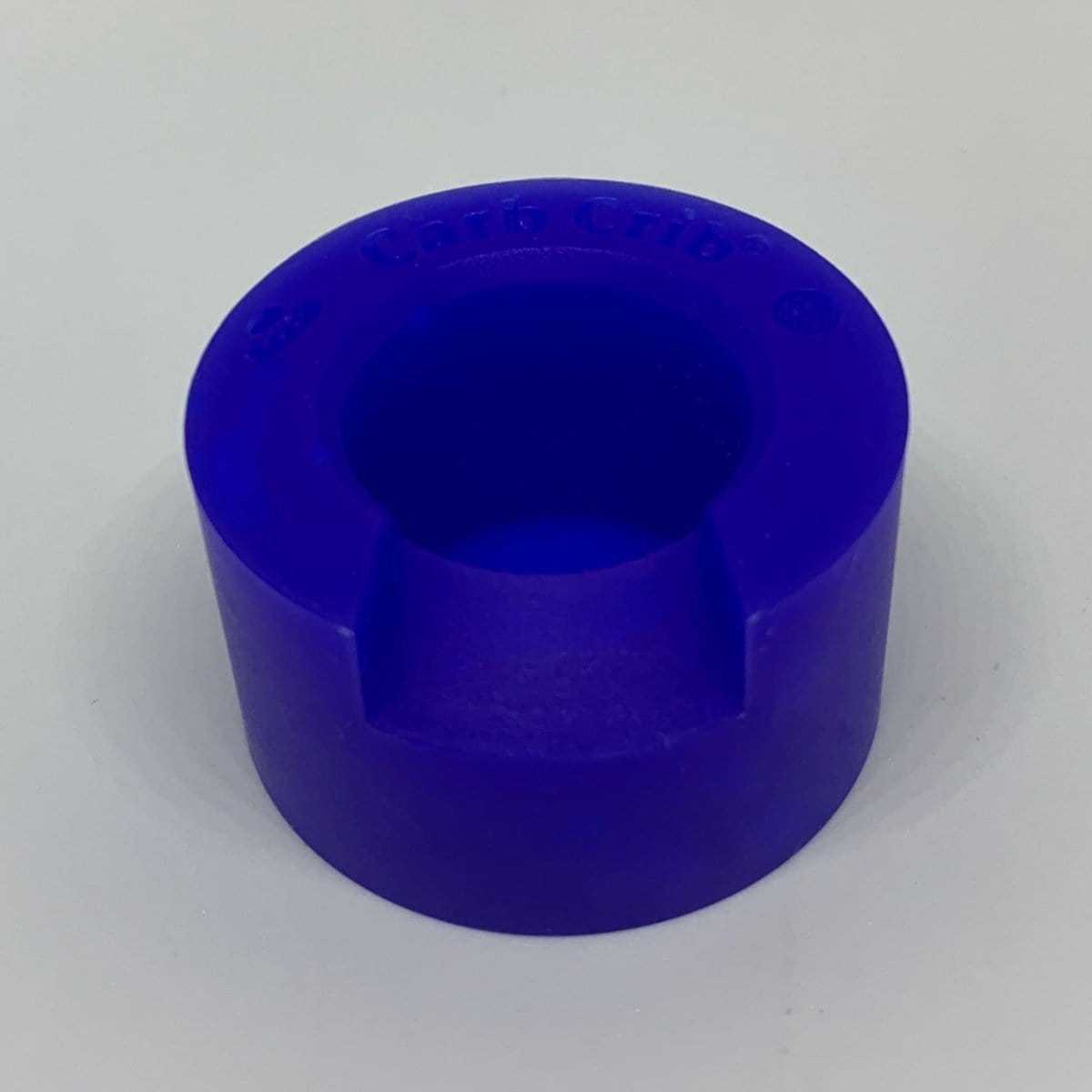 A straight-on view of the V2 Carb Crib®, featuring a blue, cylindrical form with a smooth, matte finish against a plain white background.