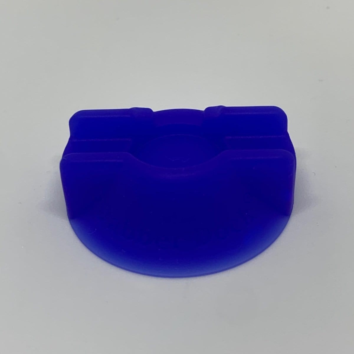 A slightly angled, top-down view of the V2 Dabber Dock®, a dark blue stand with a curved design.