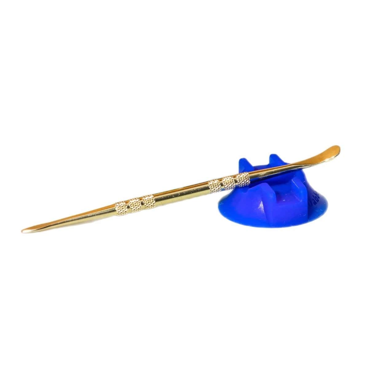 A close-up shot of the V2 Dabber Dock ® resting on a blue surface, showing its unique curved shape.