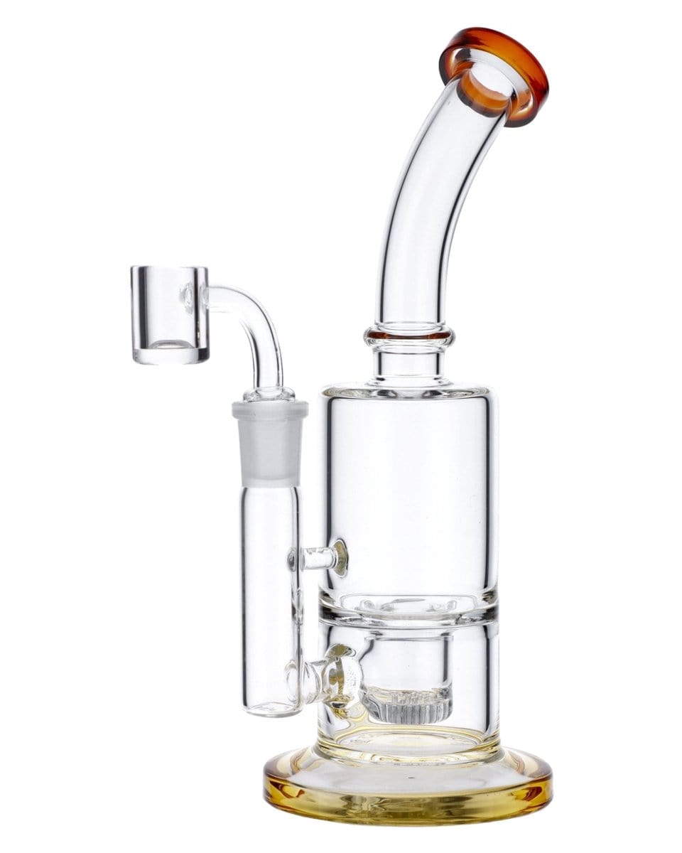 A close-up, angled view of the Amber Inset Honeycomb Perc Mini Rig, showcasing its clear glass construction and honeycomb percolator detail.