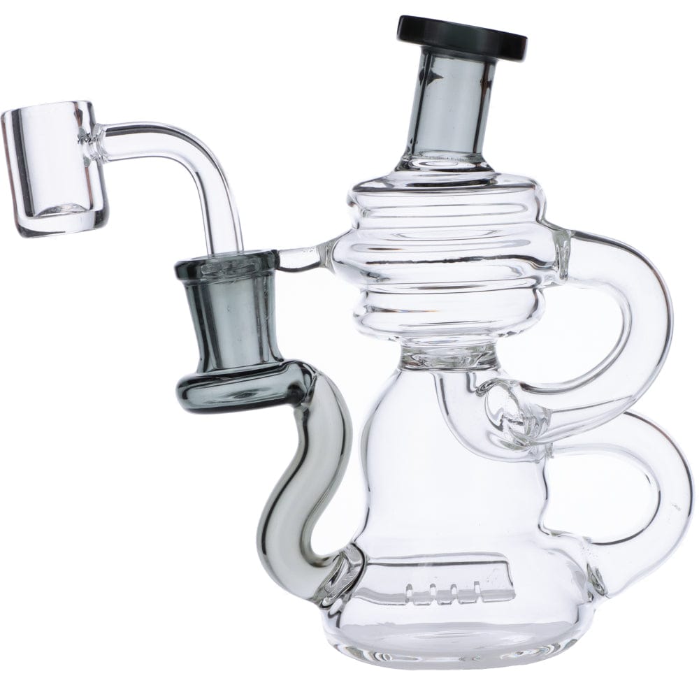 A close-up, angled view of the Mini Recycler Dab Rig, showcasing its clear glass construction and intricate bubbler design.