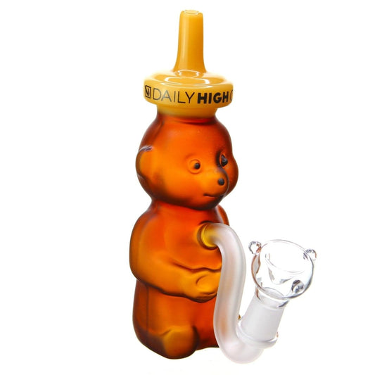 A three-quarter view of the “Daily High Club 'Brown Honey Bear'” bong, showcasing its sculpted brown glass design and joint detail.