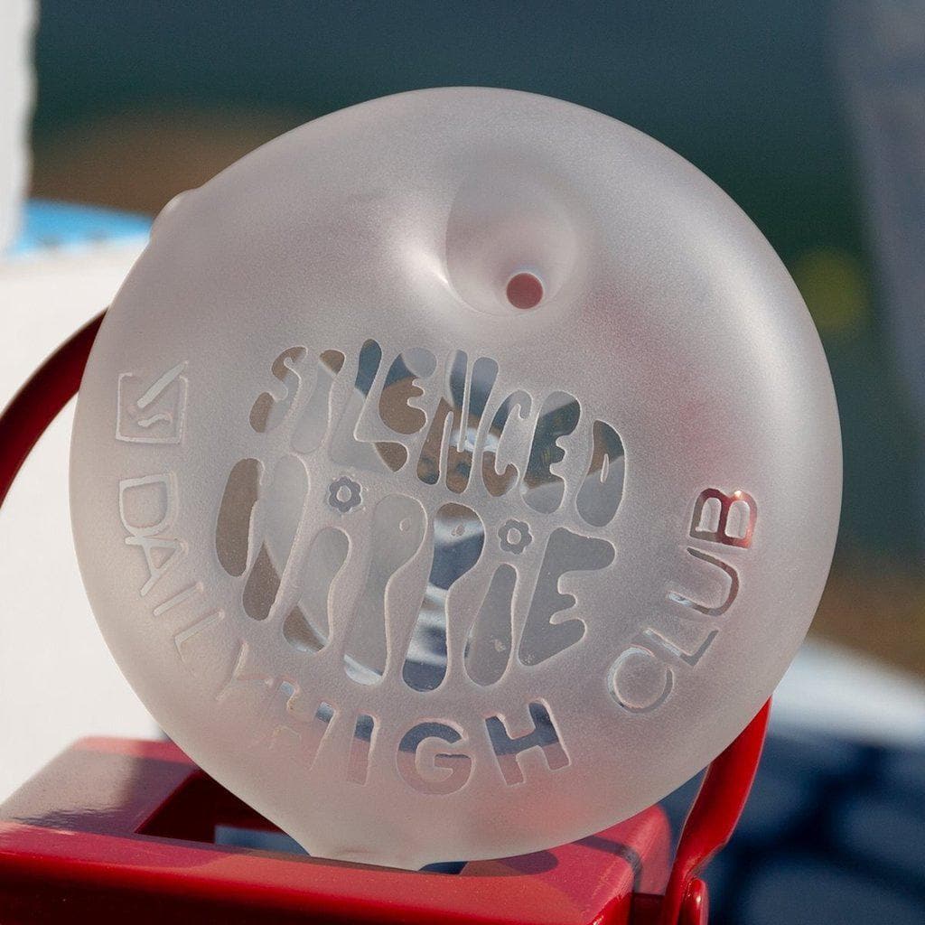 Close-up of the Daily High Club x Silenced Hippie "Peace" Pipe, showing a clear glass pipe with a unique curved design.