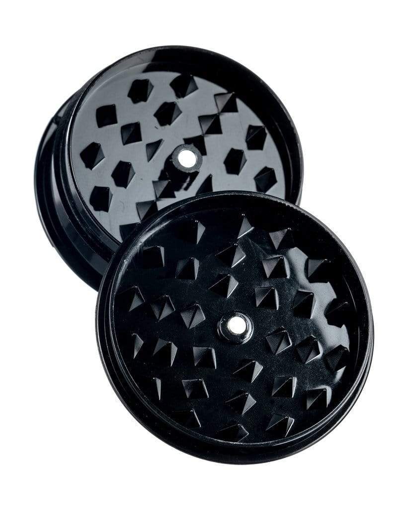 Front view of the Travel Herb Grinder & Stash Jar, showcasing its dark metallic finish and circular design against a plain white background.