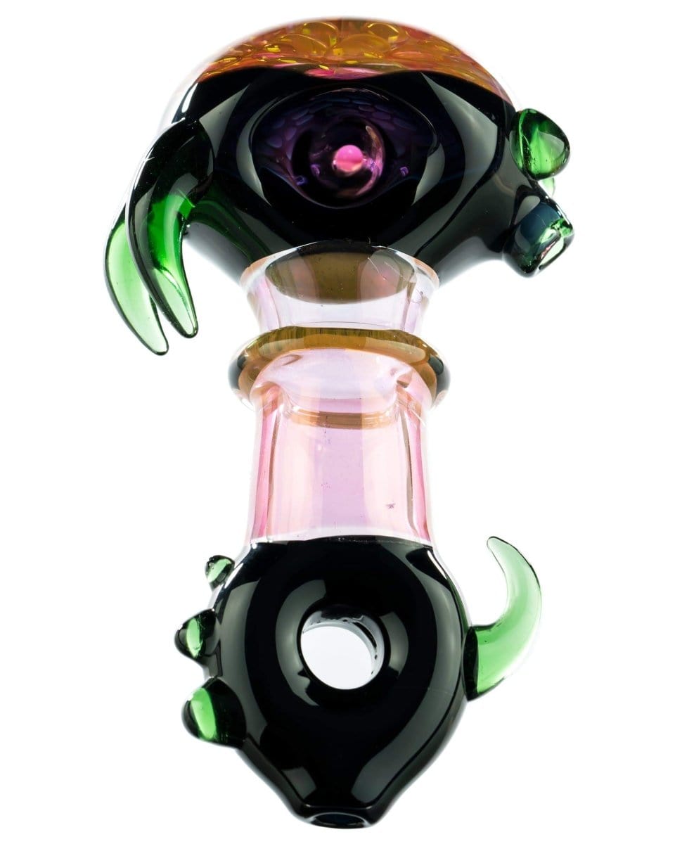 A close-up, angled view of the “Ugly Monster” Spoon Pipe, featuring a dark glass bowl with colorful, claw-like accents.