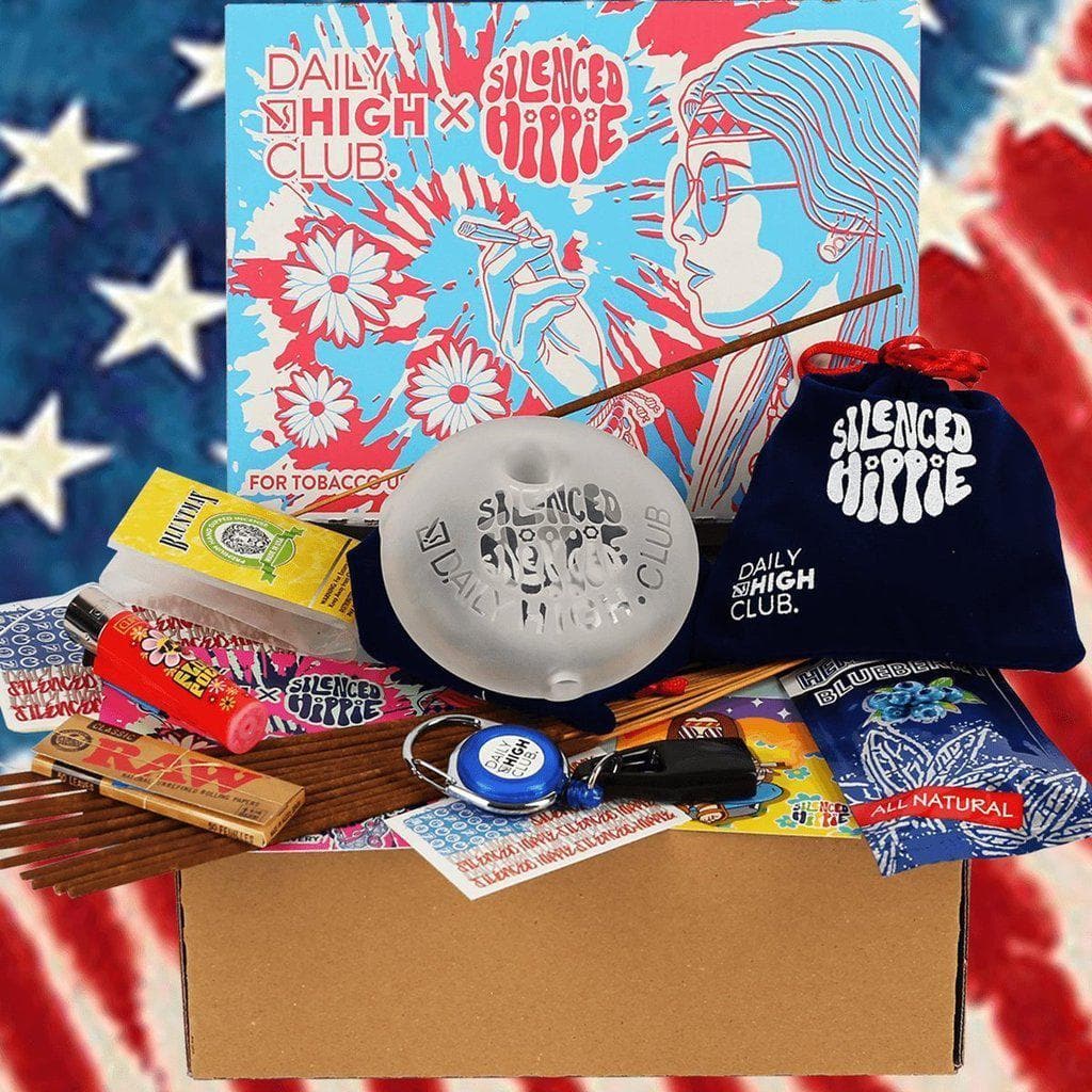 A still life featuring the “Silenced Hippie” Smoking Box alongside smoking accessories and a patterned background.