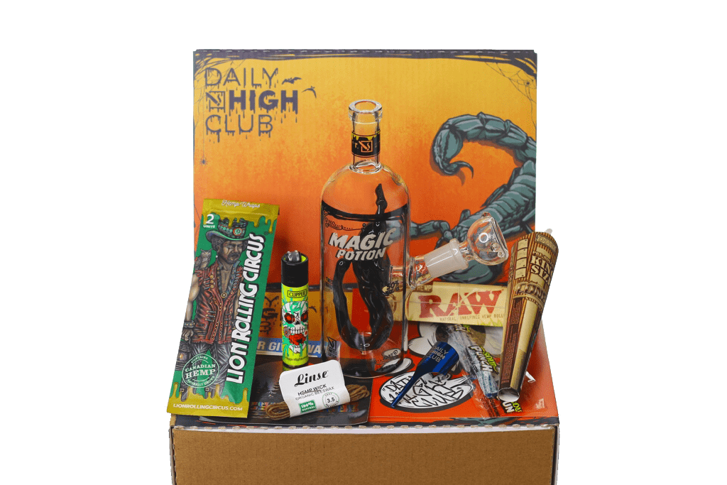 A still life of the “Spooktober Scorpion” Smoking Box, displaying accessories arranged around a small glass bottle, shot from a slightly elevated angle.