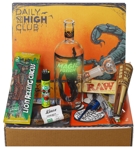 The “Spooktober Scorpion” Smoking Box is shown from above, containing a glass piece, rolling papers, and a lighter arranged within its branded packaging.