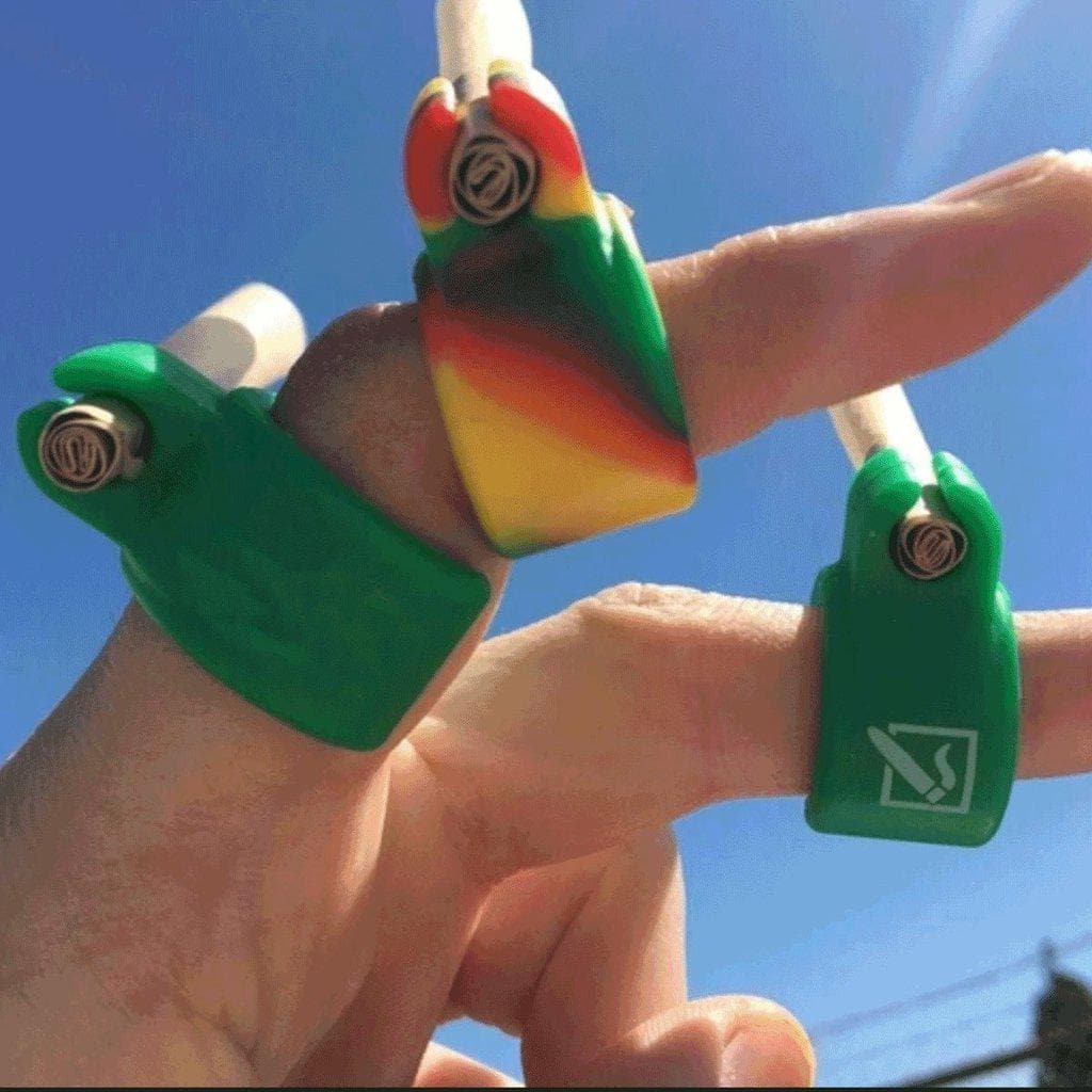 A close-up shows the DHC Originals Silicone Smoke Ring 3 Pack in vibrant colors, held against a bright blue sky.