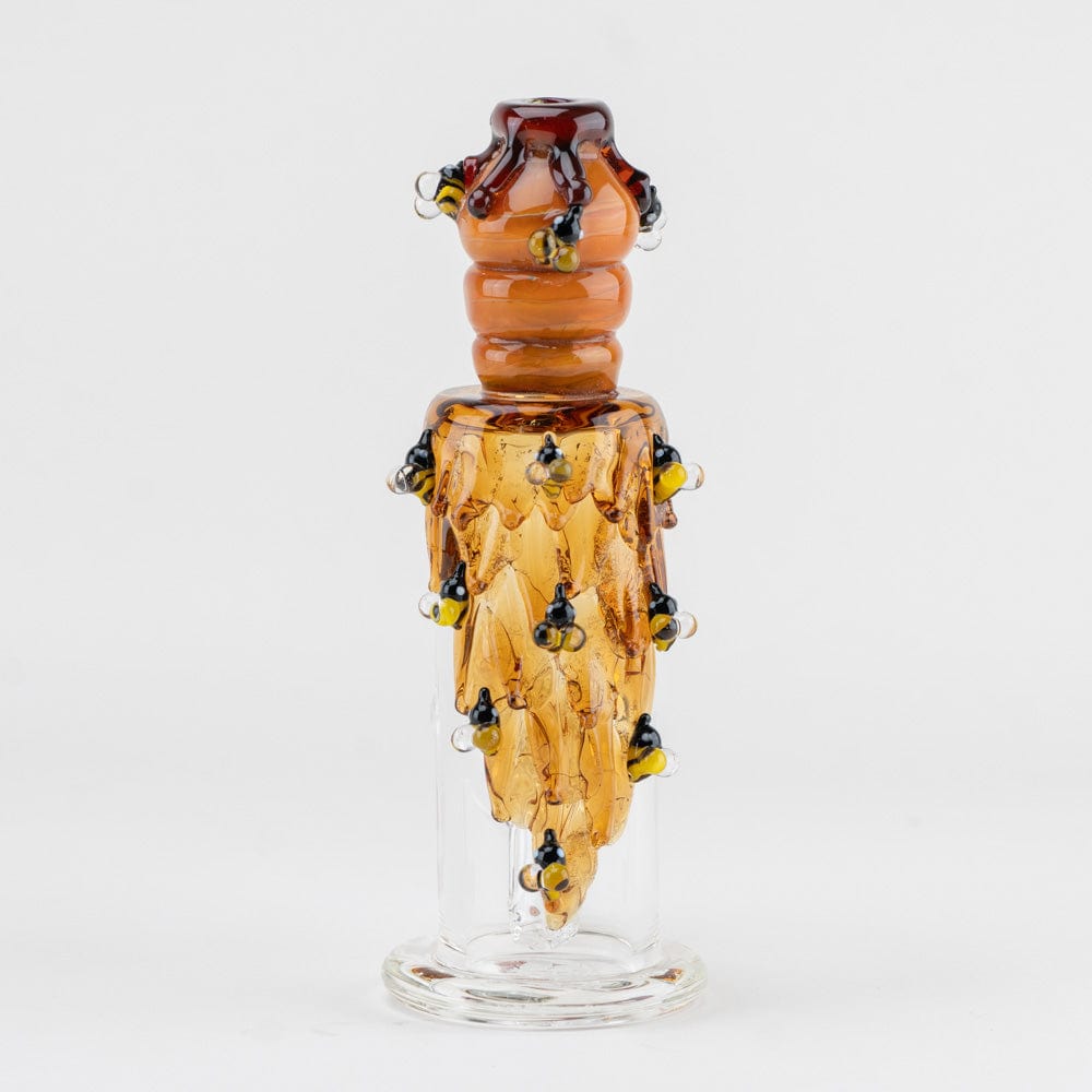 A close-up, angled view of the Beehive Nano Rig, with translucent amber glass forming a beehive-like shape.