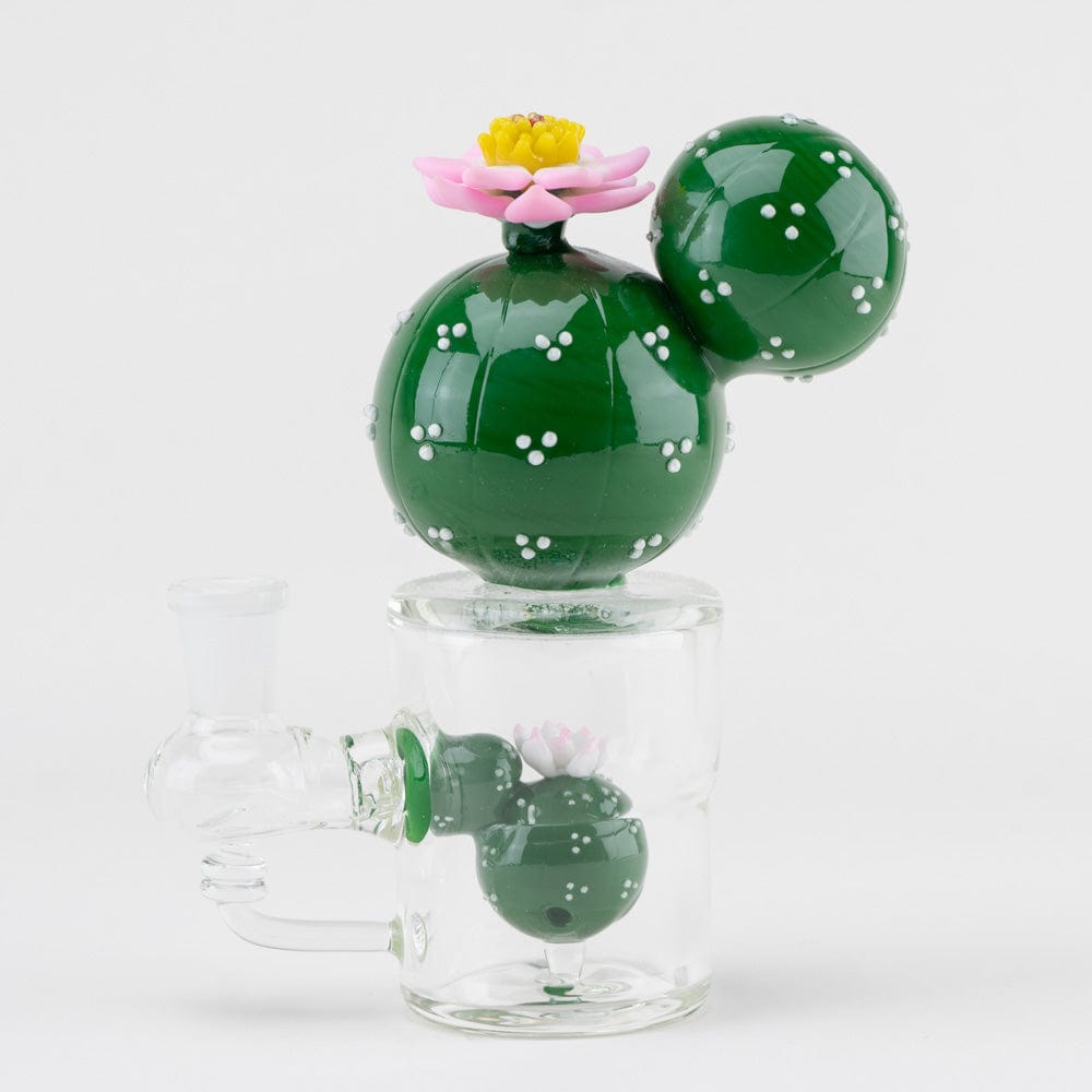 A studio shot of the Peyote Mini Rig, a small, green glass rig with a spherical design, set against a neutral background.