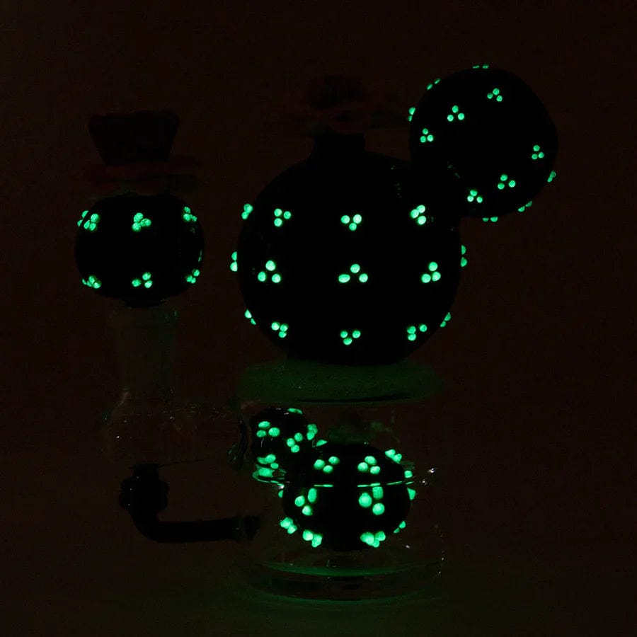 A close-up view of the Peyote Mini Rig, showcasing its clear glass construction and compact size with a dark background.