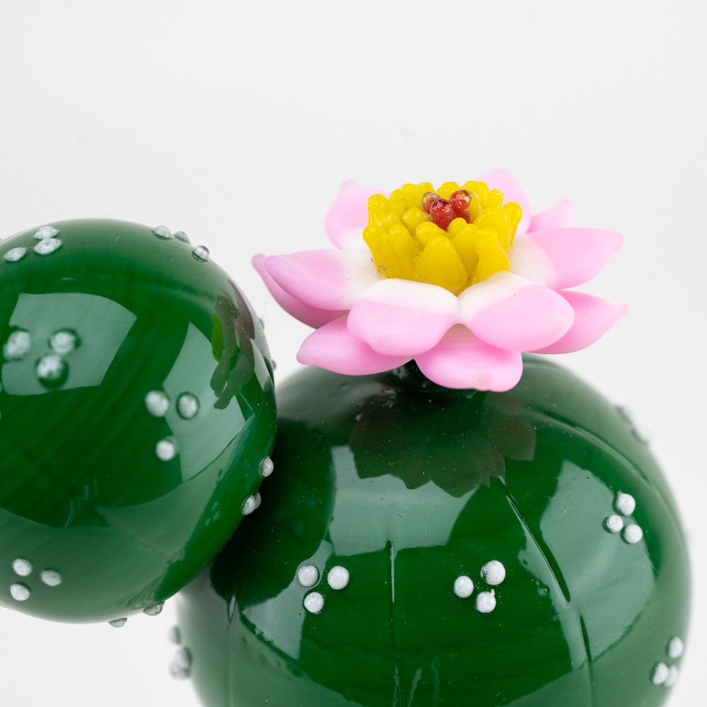 Front view of the Peyote Mini Rig, showcasing a vibrant, floral-shaped piece atop the green glass base.