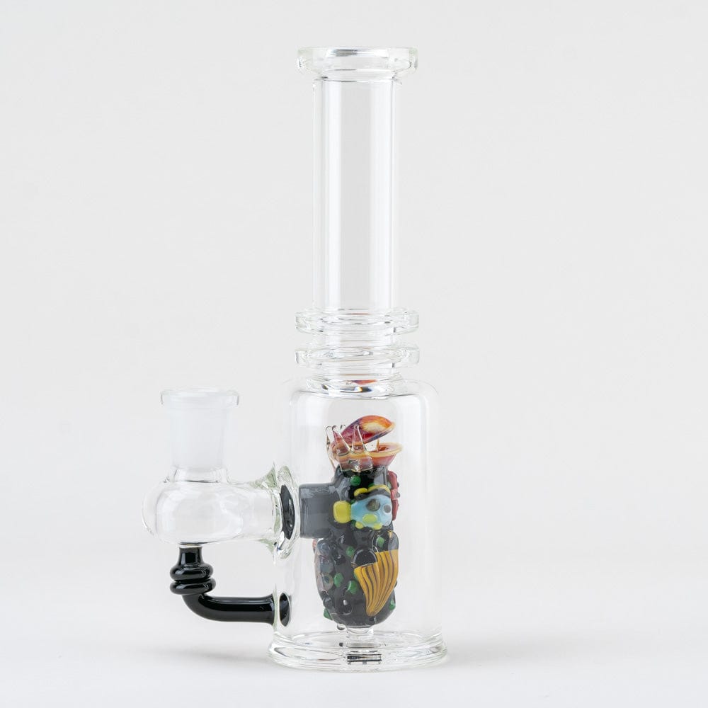Front view of the “Save the Seas” Mini Tube, a clear glass piece with marine life details, angled against a plain white background.