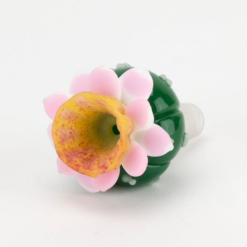 A close-up, angled view of the UV Peyote Bowl Piece, showcasing its colorful, floral-shaped design against a plain white background.