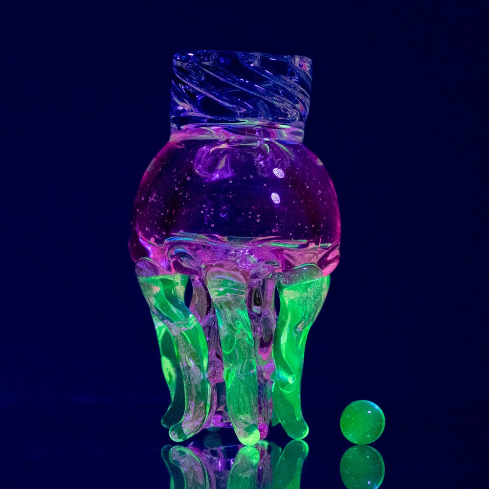 A vibrant, angled shot of the UV Jellyfish Spinner Cap, showcasing its translucent, jellyfish-like form against a dark background.
