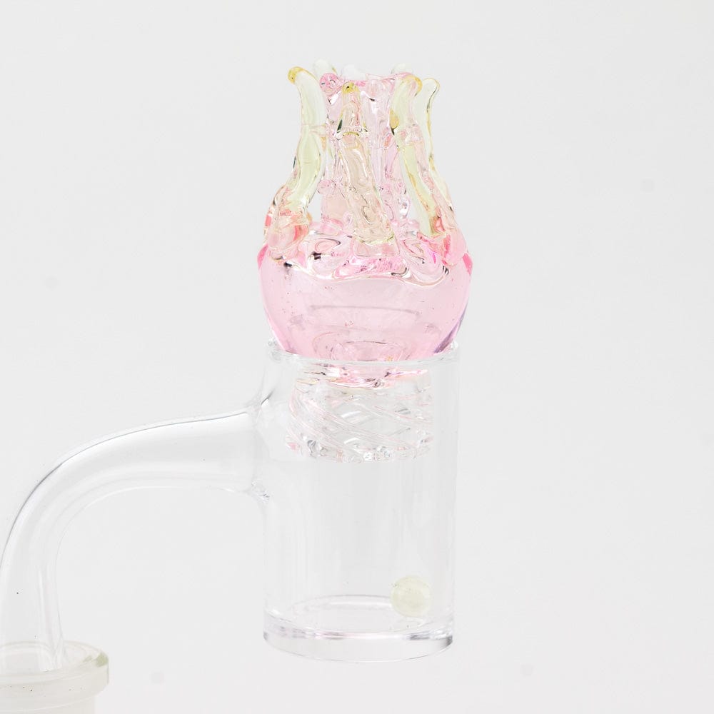 A close-up, angled view of the UV Jellyfish Spinner Cap, showcasing its translucent, colorful glass construction.
