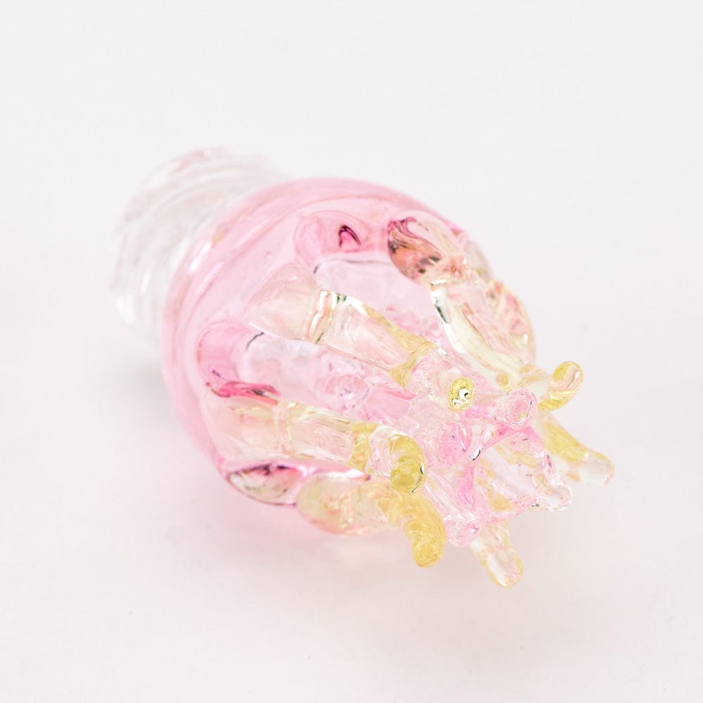 Close-up, top-down view of the UV Jellyfish Spinner Cap, showing its translucent, jellyfish-like design in shades of pink and clear glass.