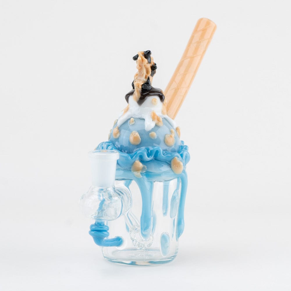 Close-up front view of the Cookie Monster Sundae Nano Rig showing a blue scoop with drips, tan wafer straw, and clear glass base.