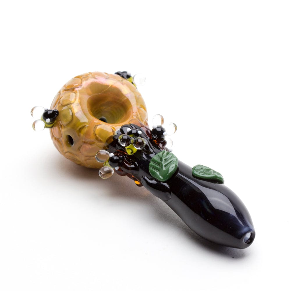 A close-up angled view of the Beehive Small Spoon Pipe, showcasing its textured, amber-colored bowl and sculpted design.