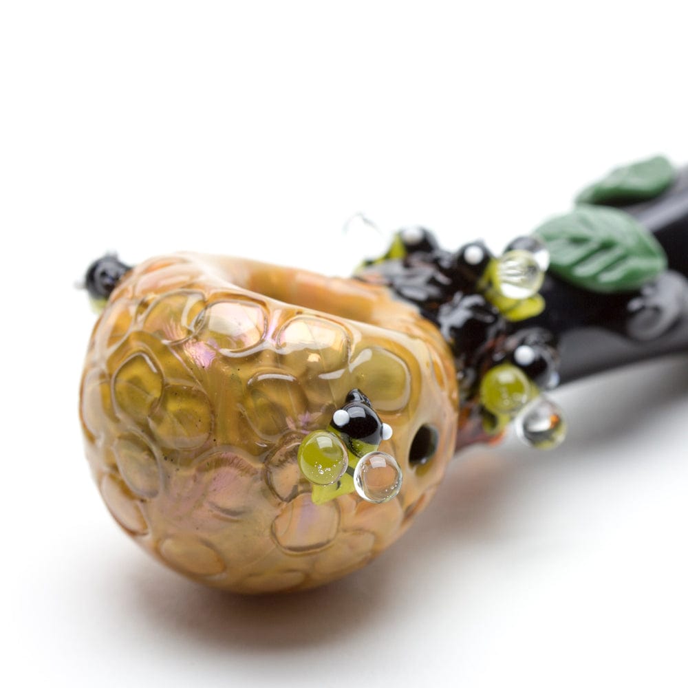 Close-up of the Beehive Small Spoon Pipe with a textured, dark-colored bowl and detailed glasswork.