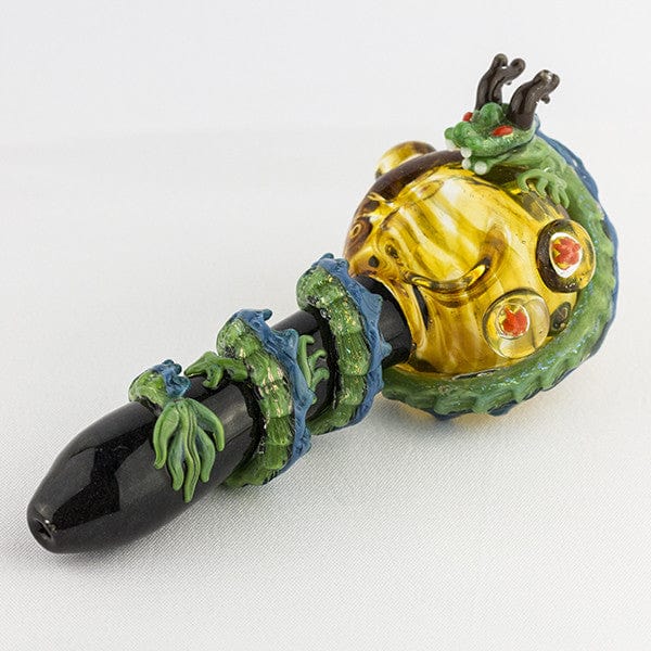 A three-quarter view of the Dragon Sphere Large Spoon Pipe, featuring a detailed, sculpted dragon design in shades of green and gold.