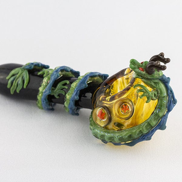 Close-up angled view of the Dragon Sphere Large Spoon Pipe, showcasing its detailed sculpted design in dark and light shades.