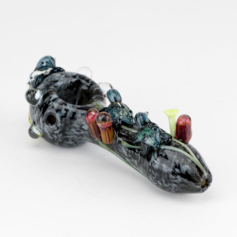 A detailed side view of the East Australian Current Small Spoon Pipe, showcasing its glass swirls and compact design.