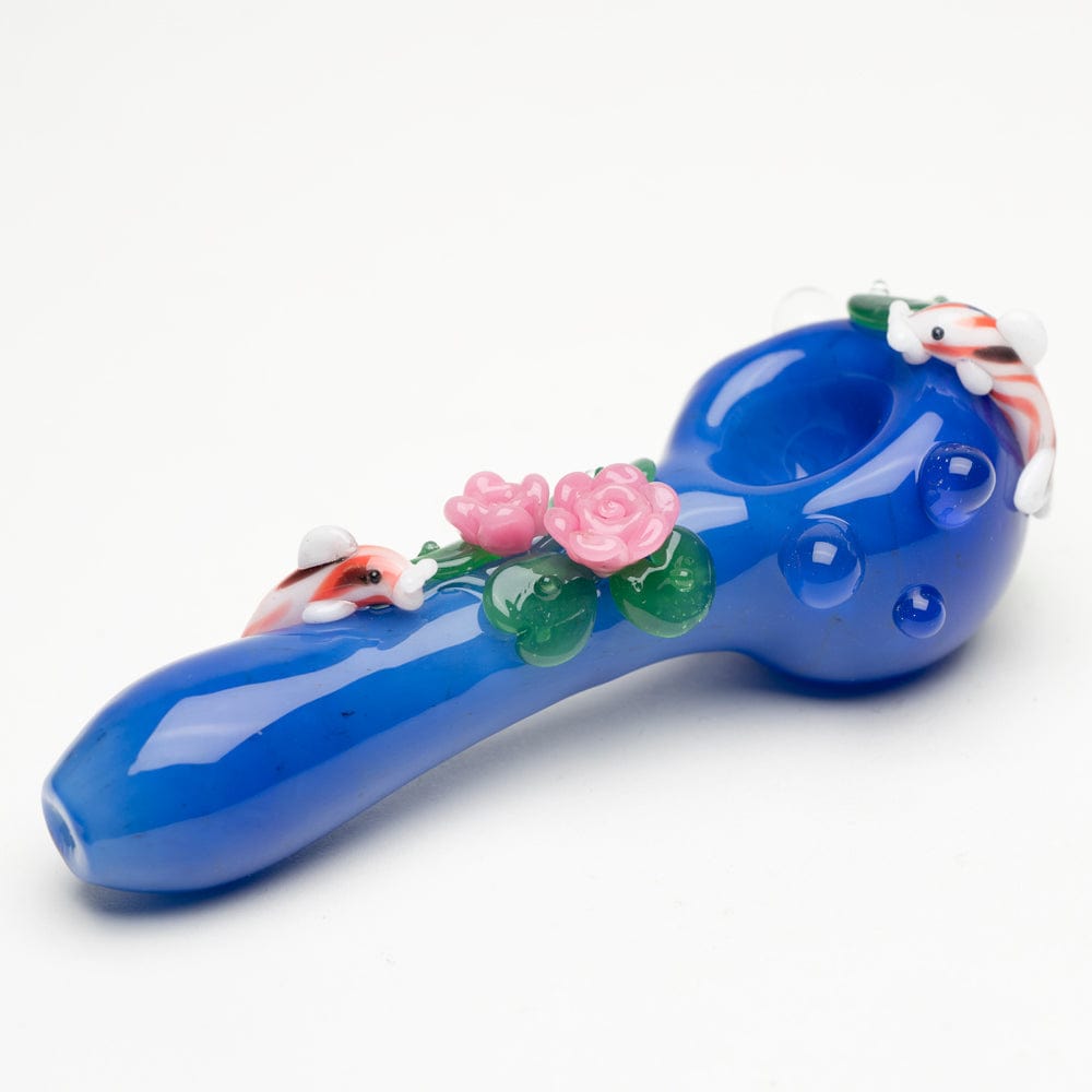 A side view of the Koi Pond Mini Spoon Pipe shows a blue glass pipe adorned with sculpted floral details.