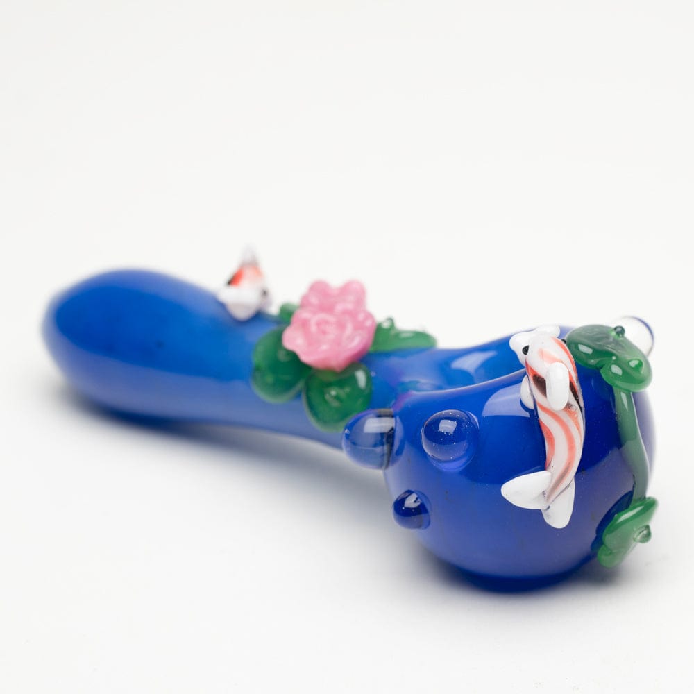 A side view of the Koi Pond Mini Spoon Pipe shows sculpted floral details and a koi fish design on a blue glass pipe.