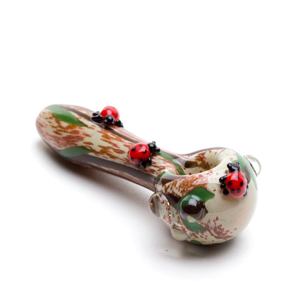 A side view of the Lady Bug Mini Spoon Pipe, showing the colorful ceramic design and curved shape against a plain white background.