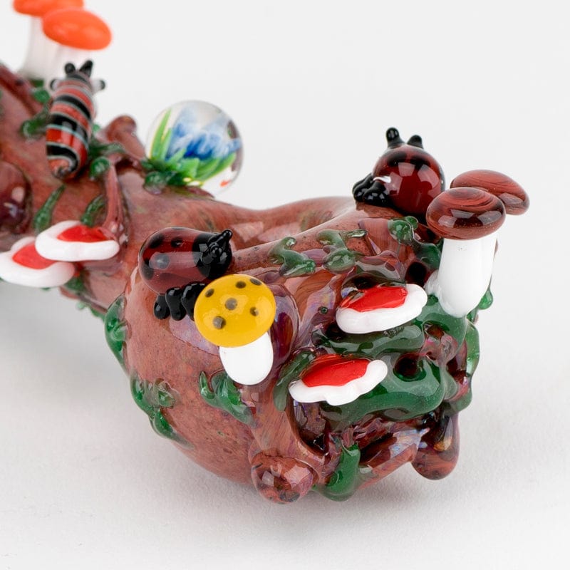 A close-up, angled view of the Ladybug Small Spoon Pipe, showcasing colorful ladybug and mushroom details on the curved glass bowl.
