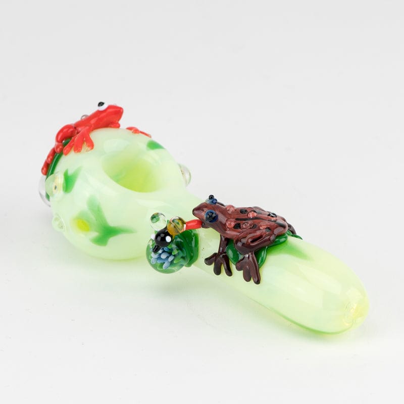 A slightly angled view of the Ribbit Small Spoon Pipe, showcasing its green glass body with a colorful, sculpted mouthpiece.