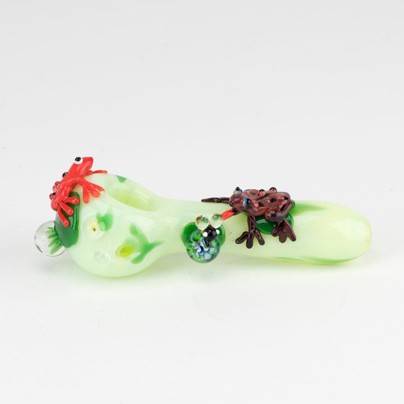 A close-up view of the Ribbit Small Spoon Pipe, featuring a sculpted frog design on clear glass.