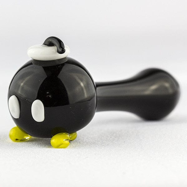 A side view of the Bomber Spoon Pipe shows a curved, dark glass pipe with small yellow accents on the base.
